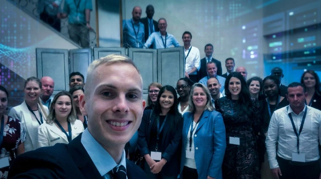 AI Workshop training – group selfie with participants in a modern office building